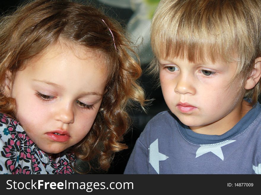 2 cute concentrated siblings playing