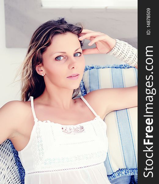 Portrait of Young pretty woman relaxing on a sofa in her home. Portrait of Young pretty woman relaxing on a sofa in her home