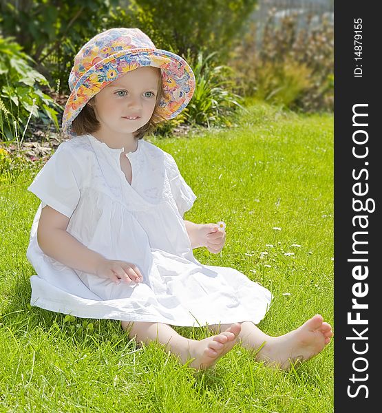 Tree years old girl in the garden