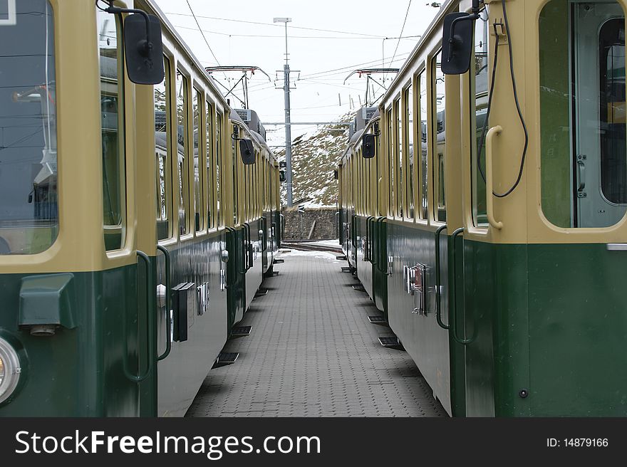 The railway platform with two standing train, Alps, Switzerland