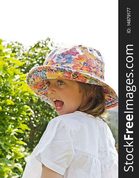 three years old girl with hat in the summer garden. three years old girl with hat in the summer garden