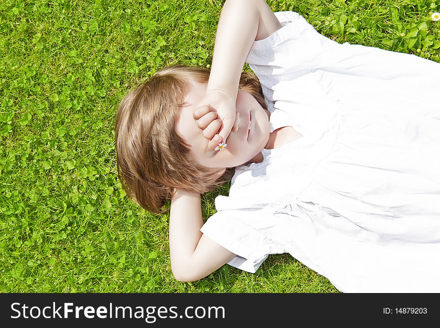 Tree years old girl sleaping on the grass. Tree years old girl sleaping on the grass