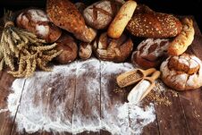 Different Kinds Of Bread And Bread Rolls On Board From Above. Kitchen Or Bakery Stock Photos