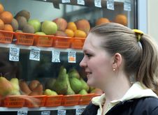 Young Woman Looking At Fruit Royalty Free Stock Photo