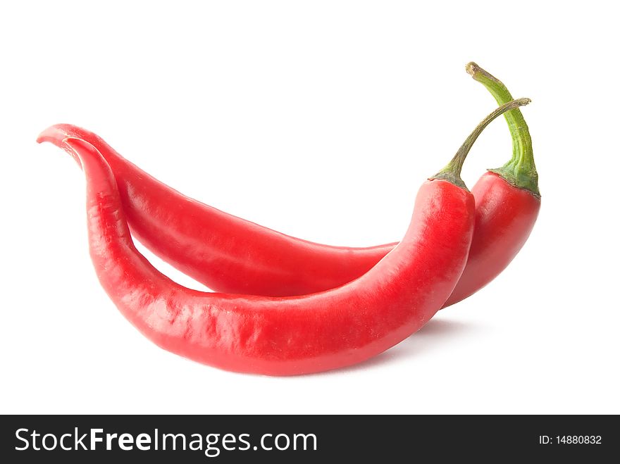 Two chili peppers on white