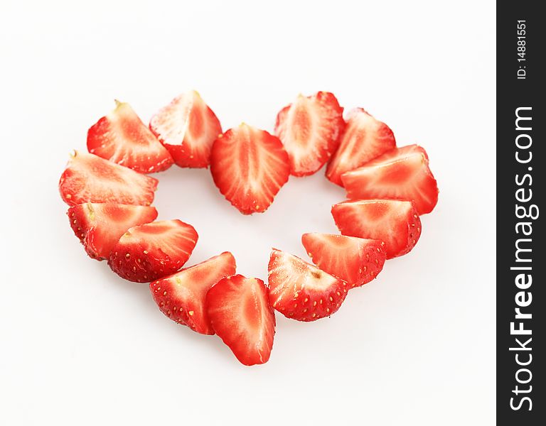 Wedges of fresh strawberries arranged in a heart shape. Wedges of fresh strawberries arranged in a heart shape