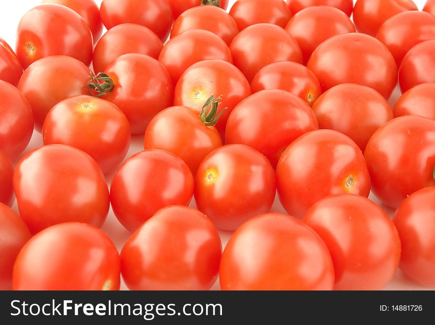 Shiny red cherry tomatoes background. Shiny red cherry tomatoes background