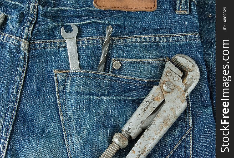 Work tools in jeans back pocket. Work wear theme
