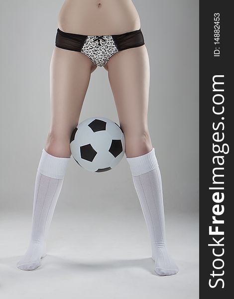Soccer legs on grey background wearing lingerie