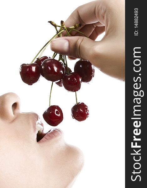 Sweet cherry in the girl's lips