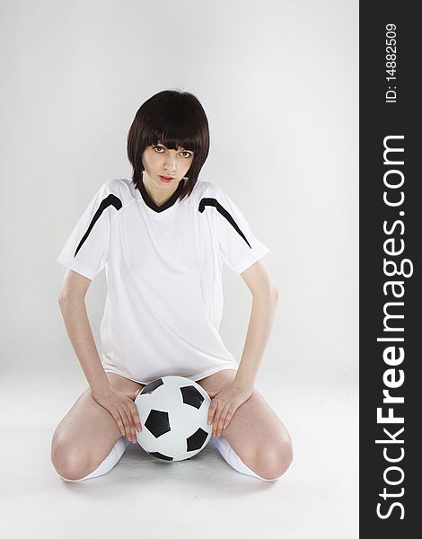 Cute sexy player posing with ball on white background