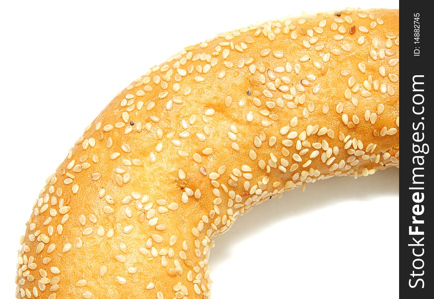 A part of bagel with sesame seeds