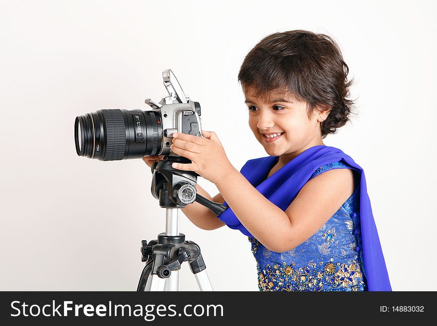 Sweet and pretty toddler playing with camera and taking picture.