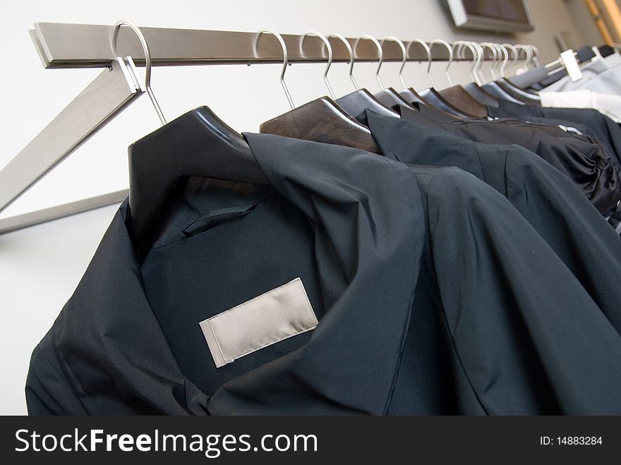 Black clothes on the racks in a store. Black clothes on the racks in a store