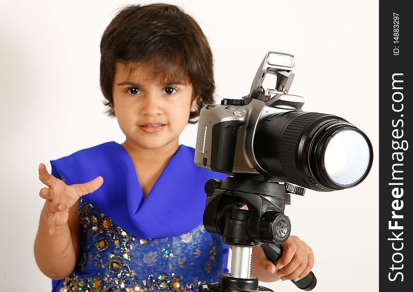 Sweet and pretty toddler playing with camera and taking picture.