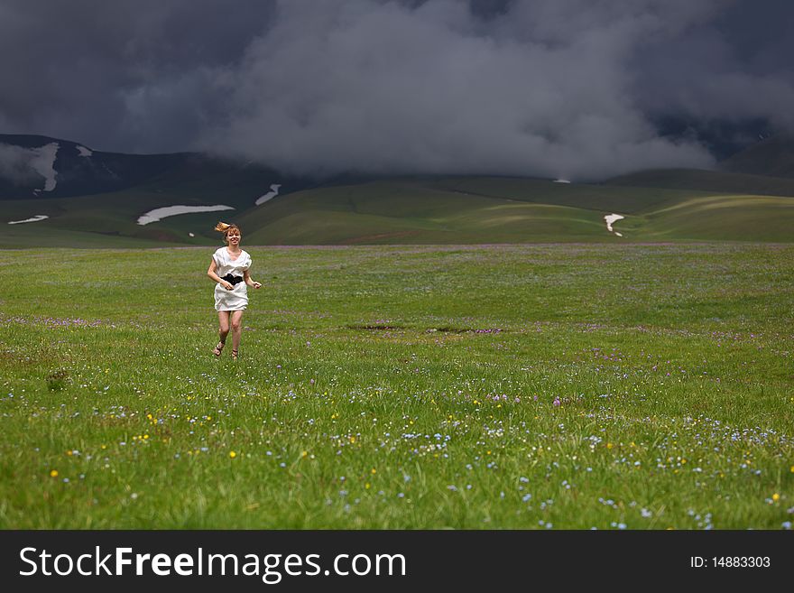 The beautiful girl on a blossoming field. The beautiful girl on a blossoming field