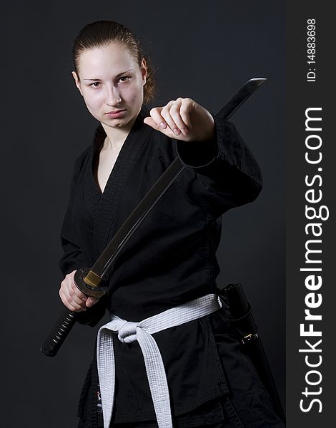 Female samurai holding katana, studio shot