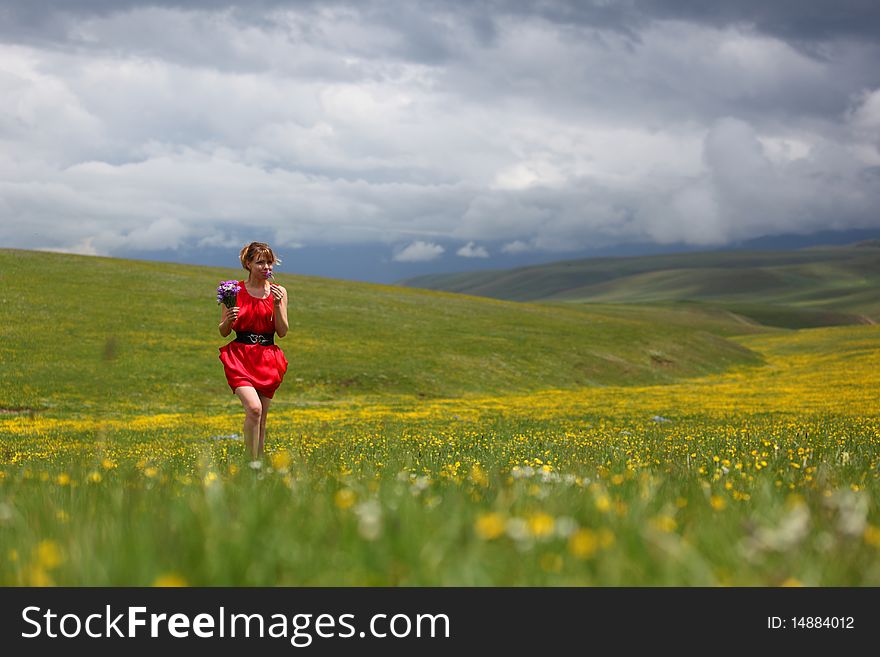 Girl in a red dress in the mountains. Girl in a red dress in the mountains