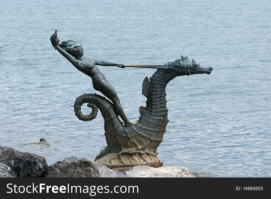 Vevey, Switzerland, northern shore of Lake Geneva, sculpture in the form of a girl with a seashell on the seahorse