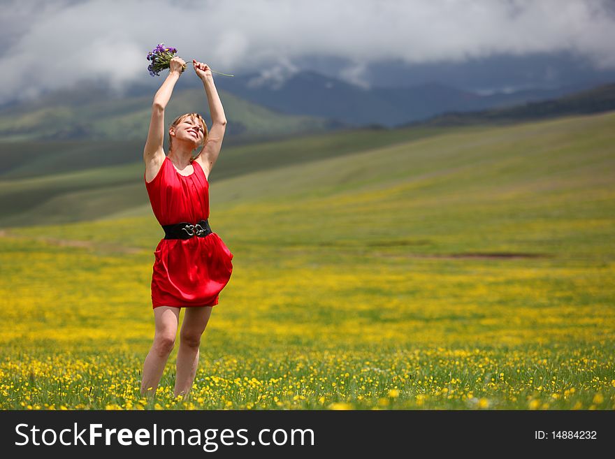 Girl in a red dress in the mountains. Girl in a red dress in the mountains