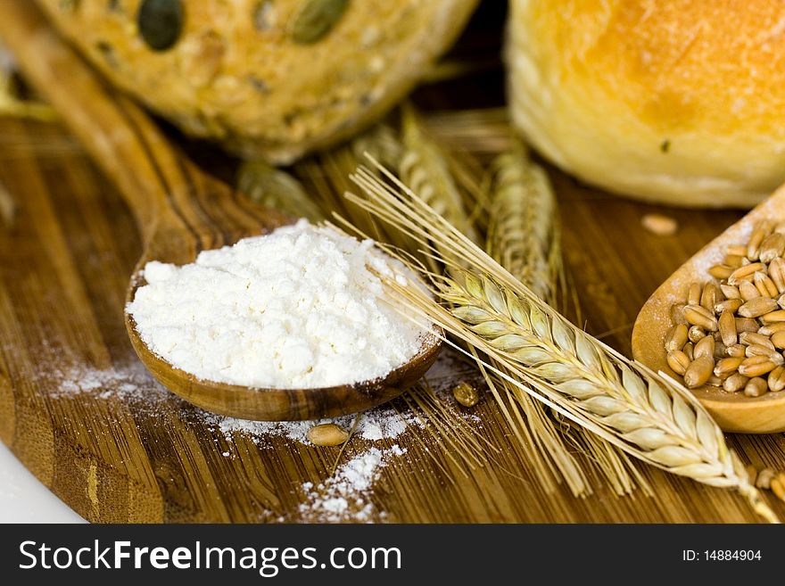 Roll bread with pumpkin and poppy seeds on the white background. Roll bread with pumpkin and poppy seeds on the white background