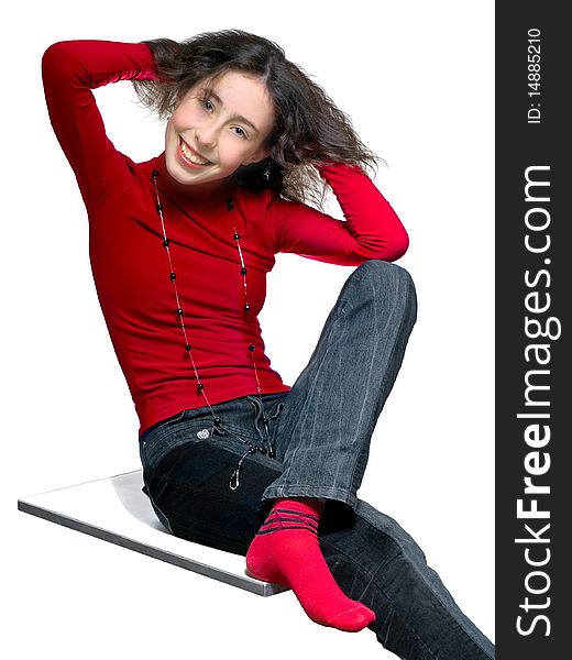 Teenager girl sitting l in gray jeans and red blouse holds her hair in her hands and smiles. isolated. Teenager girl sitting l in gray jeans and red blouse holds her hair in her hands and smiles. isolated