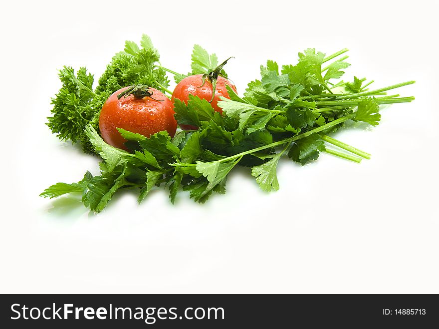 Freshly cut parsley and celery with tomatoes on a white background. Freshly cut parsley and celery with tomatoes on a white background