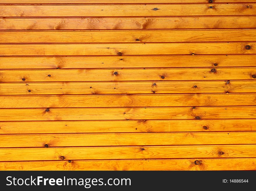 An outdoor wall made of wood planks painted in oil. An outdoor wall made of wood planks painted in oil.