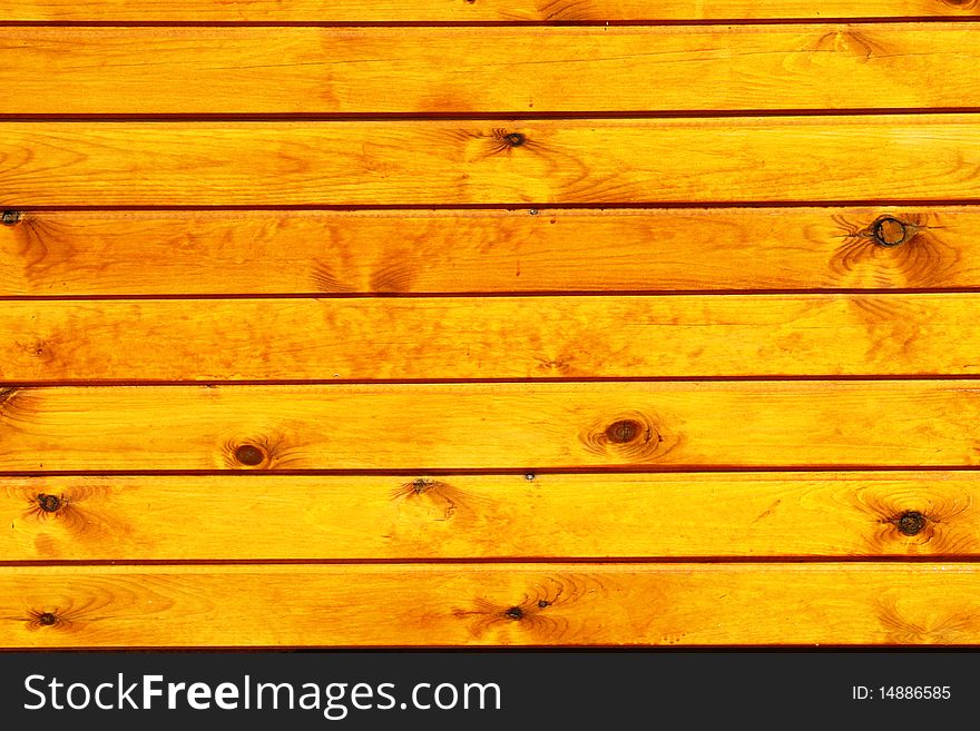 An outdoor wall made of wood planks painted in oil. An outdoor wall made of wood planks painted in oil.