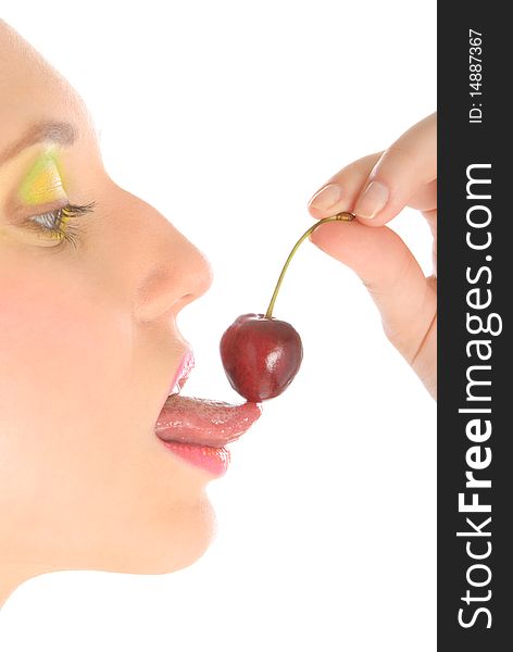 Woman with make-up licks cherry isolated in white