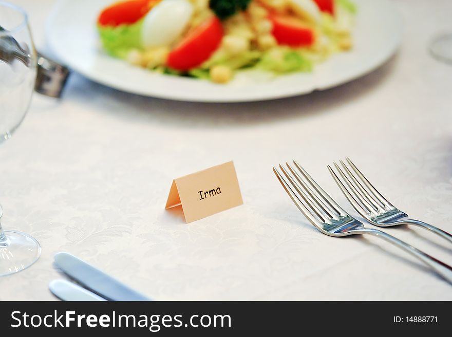 Table appointments for dinner in restaurant. Detail of table set for holiday dinner