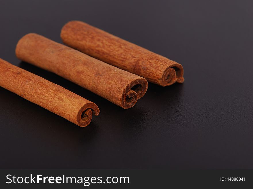 Two cinnamon sticks isolated on black background. Close up.