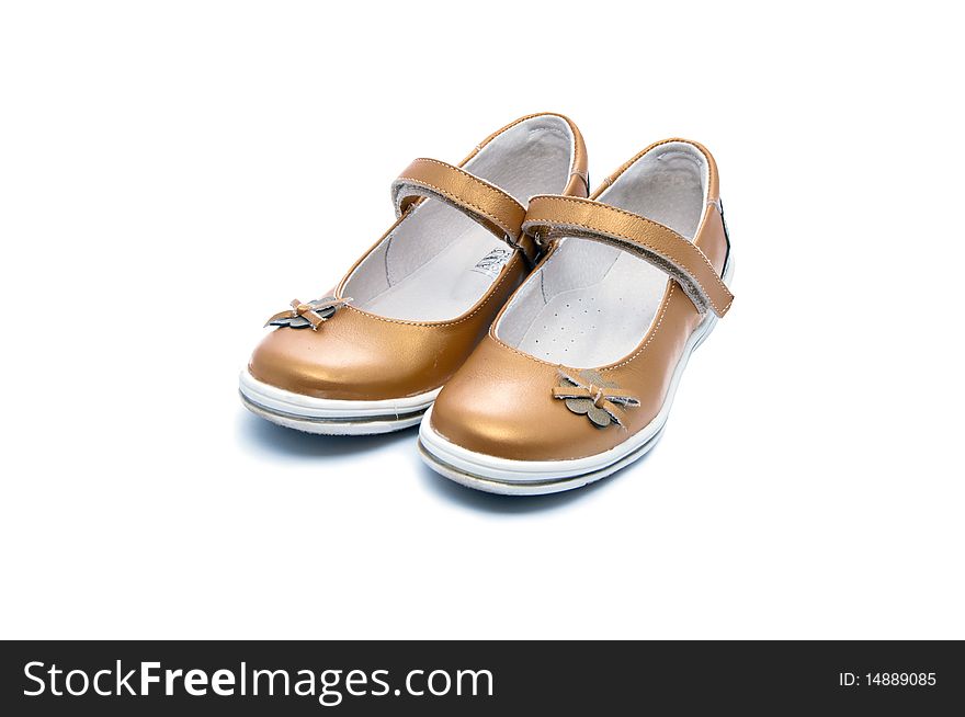 A pair of young lady golden shoes. A pair of young lady golden shoes