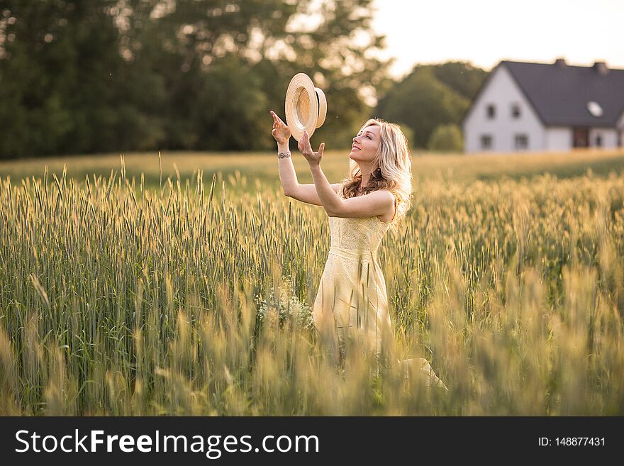 Sunset In Summer.Rural Life.A Young Woman In The Field Throws A Hat. Rustic Style