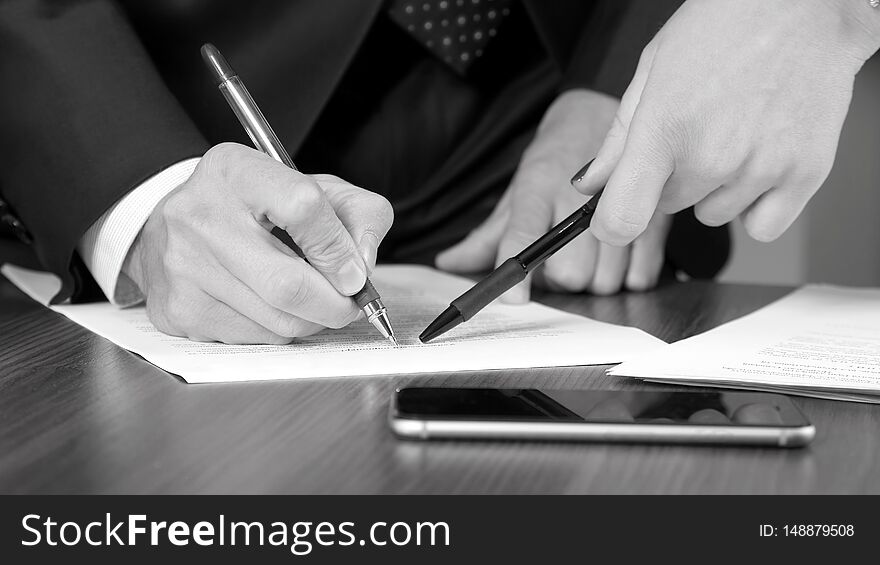 Hands of business men and women studying the documents. conclusion of business agreements