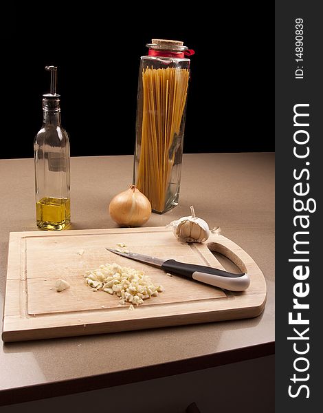 Wooden chopping board with chopped up garlic. Wooden chopping board with chopped up garlic