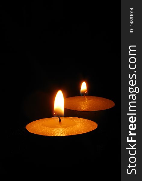 Burning candles on a dark background with warm light