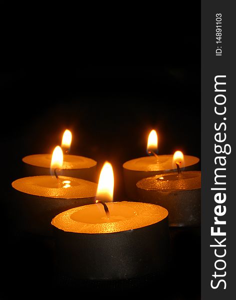Burning candles on a dark background with warm light