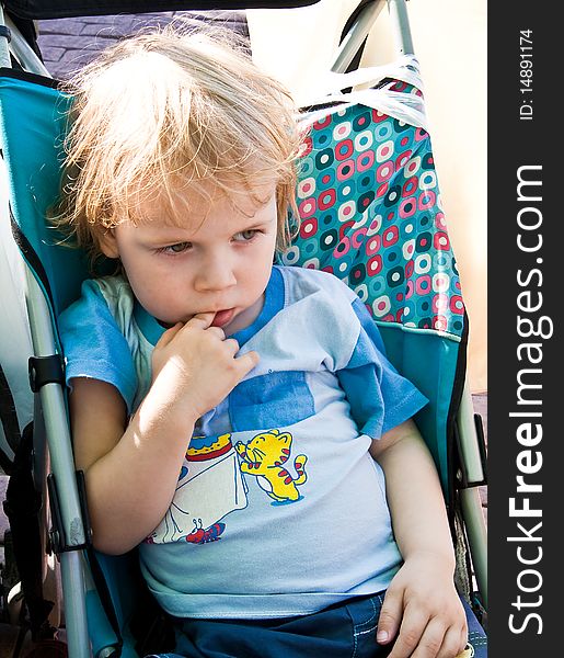 Portrait of thinking boy with a finger in his mouth. Portrait of thinking boy with a finger in his mouth