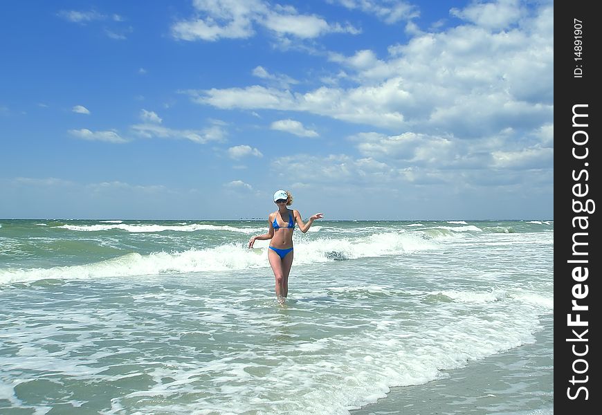 Woman goes from the sea. Kinburn Spit, near Ochakiv, Ukraine