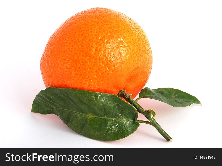 Tangerine with green leaves and water drops isolated on white