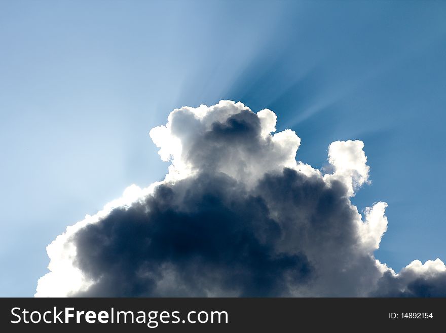 Sunrays breaking through behind a cloud