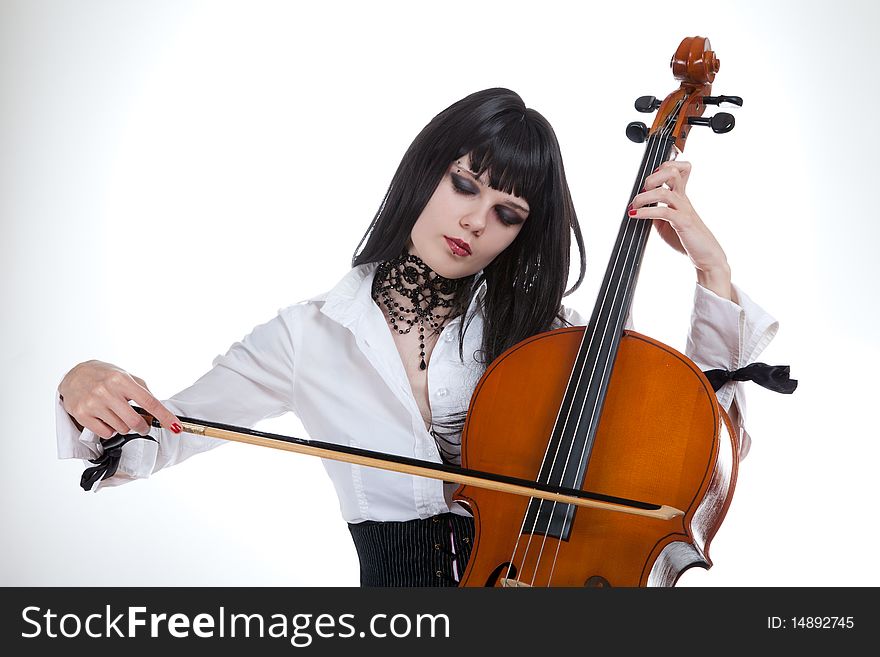 Portrait of attractive girl playing cello, studio shot over white background