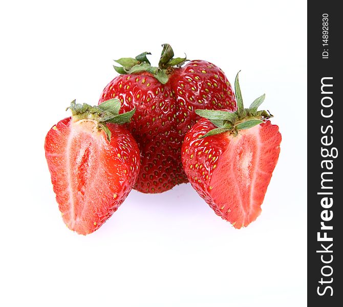 Strawberries on white background (a whole one and two halves)