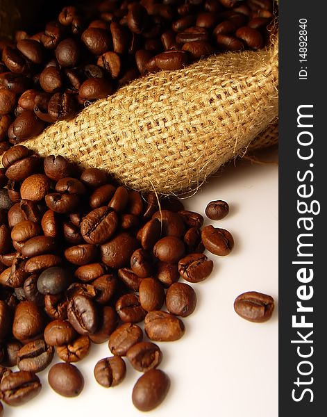 Roasted Coffee beans with coffee bag on white background