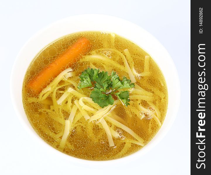 Chicken soup with macaroni and carrots decorated with parsley