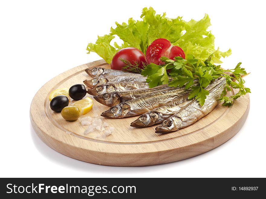 A composition with smoked clupea herring fish (Clupea harengus membras) on wooden plate isolated on white. A composition with smoked clupea herring fish (Clupea harengus membras) on wooden plate isolated on white