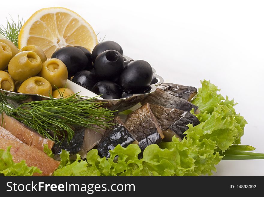 A composition with herring pieces and vegetables isolated on white. Closeup. A composition with herring pieces and vegetables isolated on white. Closeup