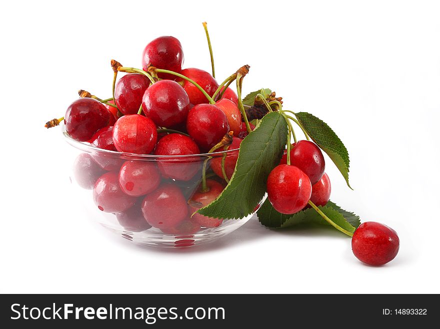 Berries are sweet cherries in a glass vase on a white background. Berries are sweet cherries in a glass vase on a white background