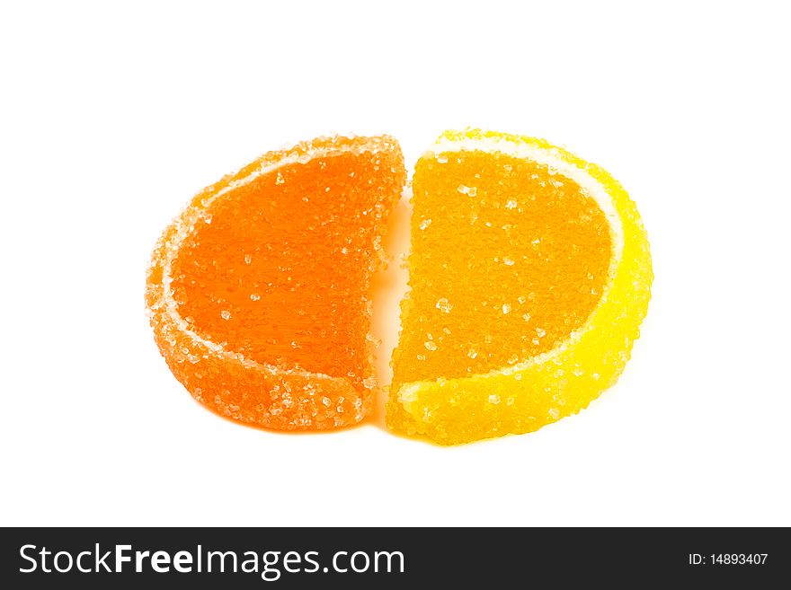 Slices of orange and lemon marmalade on a white background. Slices of orange and lemon marmalade on a white background